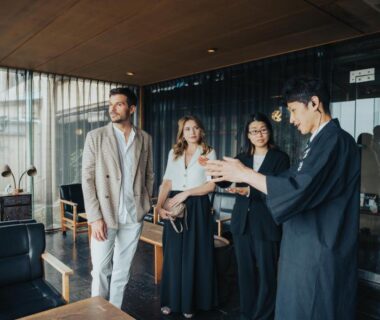 Staff in traditional attire greeting guests in wood-accent lobby at Sekitei, Hiroshima, Chūgoku, Japan
