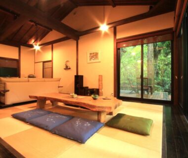 Tatami room with low table, cushions and sliding doors at Sen-no-Mori in Kumamoto, Kyūshū