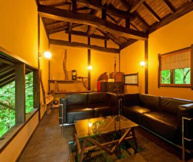 Leather sofa lounge with exposed wooden beams at Sen-no-Mori in Kumamoto, Kyūshū, Japan