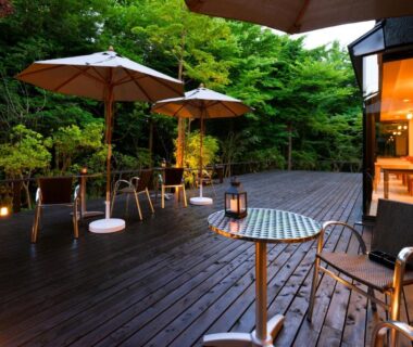Wooden deck with tables, umbrellas and lanterns at Sengokuhara Hisanoha in Kanagawa