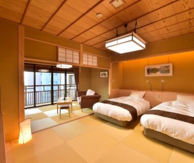 Spacious tatami room with twin beds, shoji screens and balcony at Senjukaku, Nagano, Chūbu