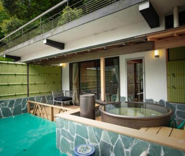 Round wooden tubs on a private deck with sliding doors and bamboo fence at Senkei in Kanagawa