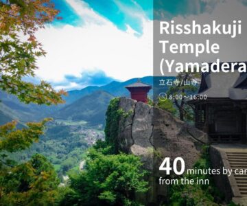 Cliffside temple overlooking a green valley near Senkeien Tsukioka Hotel in Yamagata