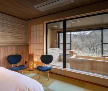 Japanese-style room with tatami, bed, shoji screens and wooden balcony tub at Senkyo, Gunma