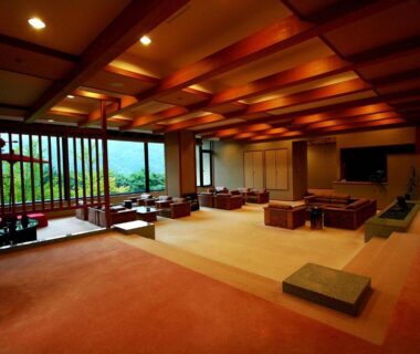 Spacious tatami lounge with low tables and wooden lattice windows at Senkyo in Gunma, Kantō