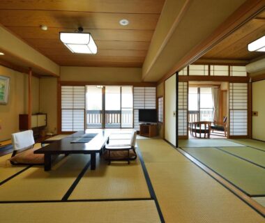 Spacious tatami room with low table, shoji screens and balcony at Senkyoro in Kanagawa