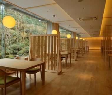 Warm wooden dining room with lattice partitions and moss garden view at Senkyoro, Kanagawa, Kantō Japan