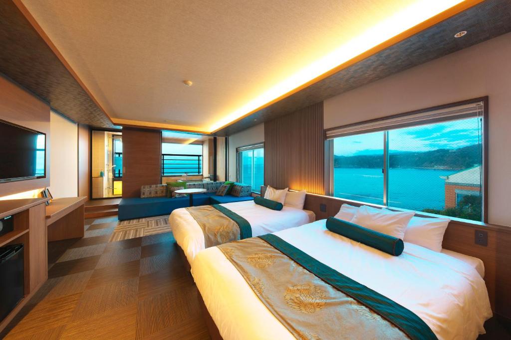 Waterview Triple Room at Senoumi Shizuoka Spacious triple room with three beds, seating area and large windows overlooking coastal waters in Shizuoka