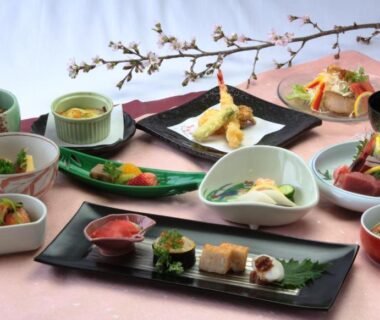 Assorted traditional Japanese small dishes on lacquer trays served in ryokan dining at Senshoen, Hokkaidō