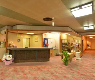 Reception desk and seating area with floral arrangements in Senso Yutagawa lobby, Yamagata