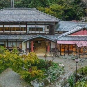 Traditional wooden ryokan building with garden and mountain foliage at Senzairou in Gifu, Chūbu region