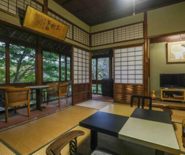 Traditional tatami room with low table, shoji screens and garden view at Senzairou in Gifu