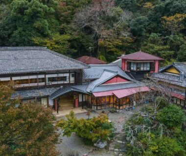 Tiled-roof ryokan buildings at Senzairou among forested hills in Gifu, Chūbu region
