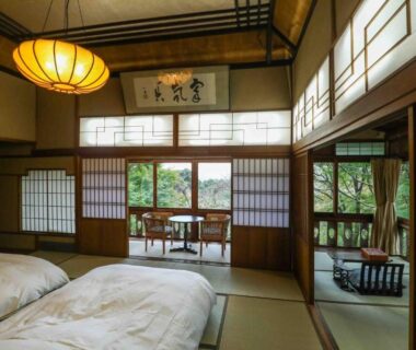 Traditional tatami room with futons, shoji screens and garden-facing veranda at Senzairou in Gifu, Chūbu