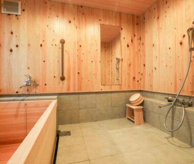 Wooden ofuro and shower area with stone floor and shoji window at Senzairou, Gifu, Chūbu