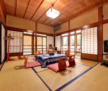 Traditional tatami room with low table, floor cushions, shoji screens and wooden ceiling in Setoguchi, Niigata
