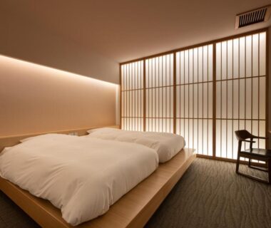 Low platform twin beds with shoji screens and chair at Shaga-no-Sato Yumeya, Niigata, Chūbu Japan