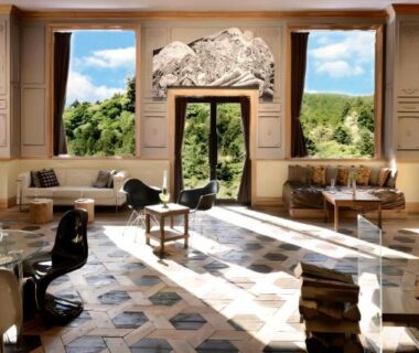 Bright lounge at Shelter Garden Nikko with armchairs and floor-to-ceiling windows overlooking green hillside in Tochigi