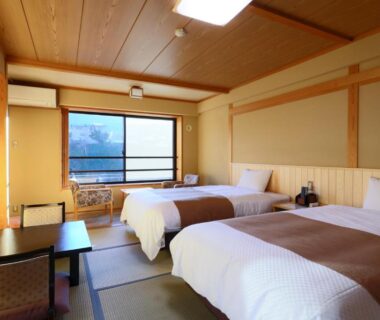 Tatami room with twin beds, low table and window, Shibu Hotel Nagano Chūbu Japan