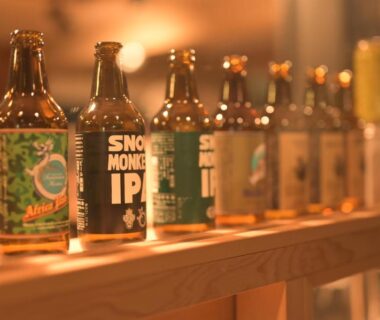 Row of bottled craft beers on a wooden rail at Shibu Onsen KADOYA Nagano