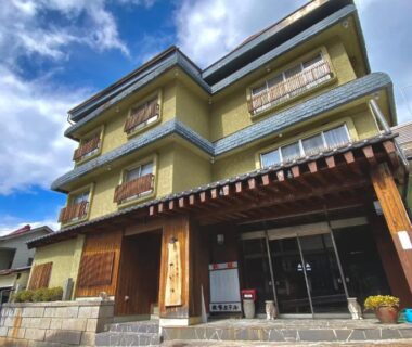 Multi-story ryokan exterior with wooden entrance at Shibu Onsen KADOYA, Nagano, Chubu