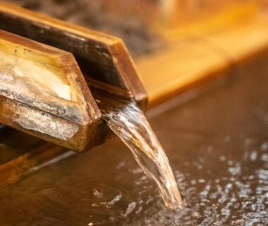 Wooden water spout filling a wooden onsen bath at Shibu Onsen KADOYA in Nagano