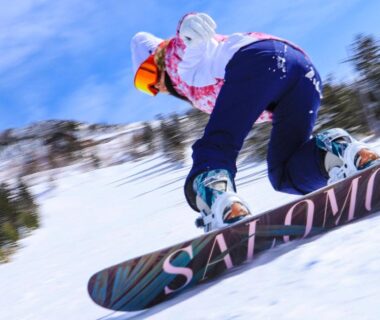 Snowboarder carving down snowy slope near Shiga Ichii Hotel, Nagano Chūbu