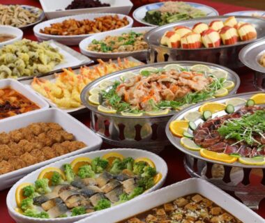 Buffet table with assorted hot and cold dishes, salads, fruits and fried items at Shiga Ichii Hotel Nagano