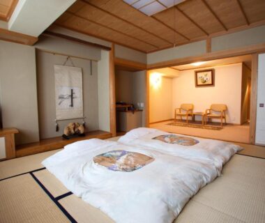 Traditional tatami room with futon bedding, shoji screens, tokonoma alcove and seating at Shiga Sunvalley Nagano