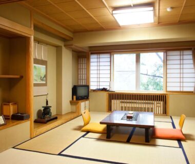 Traditional tatami room with low wooden table, floor cushions, shoji screens and decorative alcove at Shiga Sunvalley Nagano