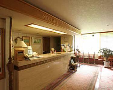 Lobby reception area with seating, potted plants and information desk at Shiga Kogen Hotel, Nagano