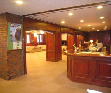 Wood-paneled lobby with reception desk and seating at Shiga Palace Hotel Nagano, Chūbu