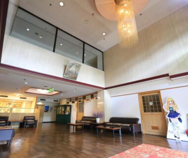 Lobby with high ceiling, chandelier, seating and character standee at Shiki-no-Yado Fujisan, Yamanashi