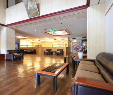 Spacious wooden-floored lobby with sofas and reception at Shiki-no-Yado Fujisan, Yamanashi