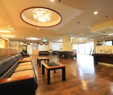 Lobby seating area with sofas, wooden floor and reception desk at Shiki-no-Yado Fujisan in Yamanashi