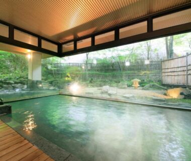 Indoor onsen bath with wooden deck and garden view at Shikitei Morioka TsunagiOnsen Iwate Tōhoku
