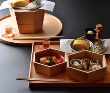 Hexagonal wooden dishes and small bowls on lacquered trays with chopsticks at Shima Onsen Yoshimoto, Gunma Japan