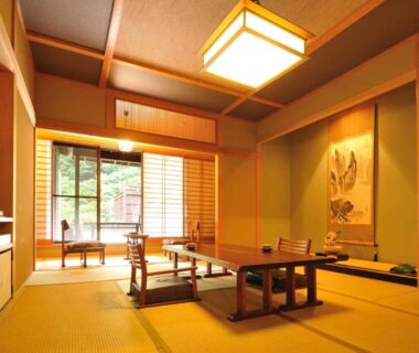 Tatami room with low table and shoji screens at Shima Onsen Yoshimoto in Gunma