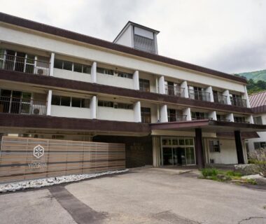 Multi-story ryokan exterior with balconies and entrance at Shima Onsen Yuzuriha in Gunma, Kantō region