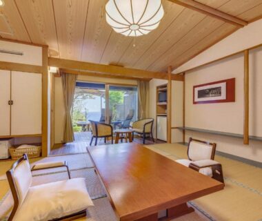 Tatami room with low table, floor cushions and sliding doors at Shimoda View Hotel, Shizuoka, Chūbu Japan