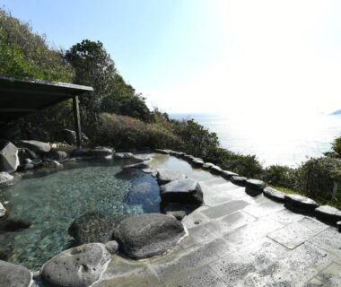 Open-air onsen bath with rock edging at Shimoda Yamatokan in Shizuoka
