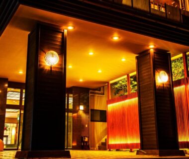 Illuminated entrance with wooden pillars and warm wall lighting at Shin Kaikatei Izumi, Shizuoka, Chūbu, Japan