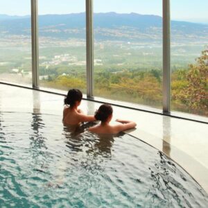 Indoor onsen pool with panoramic windows and valley view at Shinki, Gunma, Kantō