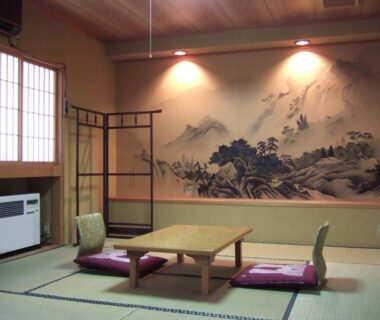 Tatami room with low table, cushions and painted mountain mural at Shinseikan, Iwate, Tōhoku, Japan