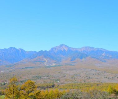 Blue sky mountain range with golden trees near Shintaku Sanso Nagano Chūbu Japan