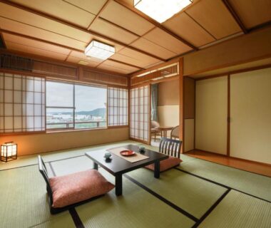 Traditional tatami room with low table, zabuton cushion and shoji screens at Shintomi-tei in Miyagi, Tohoku