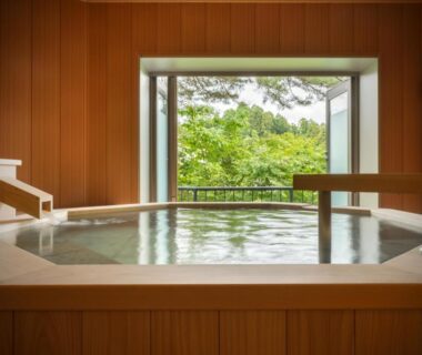 Wooden indoor soaking tub with open window overlooking green garden at Shintomi-tei, Miyagi Tōhoku