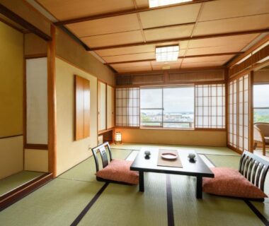Traditional tatami room with low table, zabuton cushions and shoji screens at Shintomi-tei in Miyagi Tōhoku