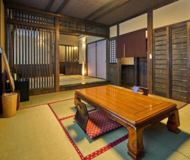 Traditional tatami room with low wooden table and shoji screens at Shinwaen, Kumamoto, Kyūshū, Japan