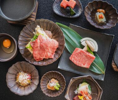 Thinly sliced wagyu and small side dishes on ceramic plates at Shinzan Kinosaki, Hyōgo, Kansai